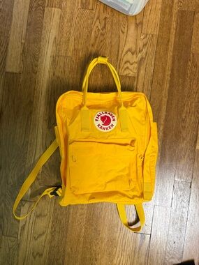 Yellow Fjällräven Kånken Classic backpack.